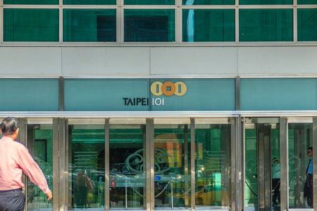Taipei, Taiwan - November 22, 2015: Tourist walking into the Taipei 101 tower, view from the front...