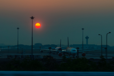 Beautiful Nature Egg Yolk Sunrise with colourful sky environment. Sun egg yolk, beautiful calm sky with orange sunrise in the morning at the airport. Morning sun egg yolk with silhouette background.の写真素材