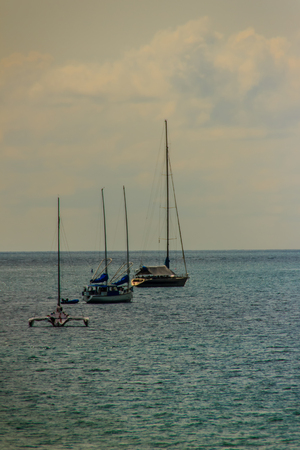 Beautiful seascape view of Nai Harn Beach Phuket with sail yachts and catamarans on backgroundの写真素材