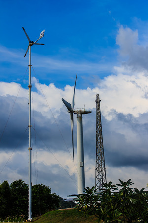 Close up of wind turbine in a wind farm against a clear blue sky producing alternative energyの写真素材