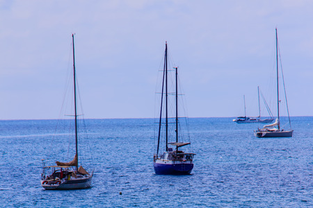 Beautiful seascape view of Nai Harn Beach Phuket with sail yachts and catamarans on background