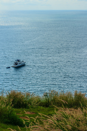  Colorful marine landscape with sail boat against deep blue sea under blue sky in the ocean on the cloudy day.の写真素材