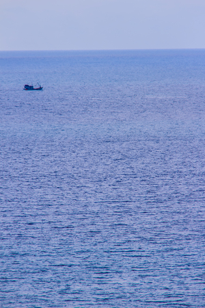 Colorful marine landscape with sail boat against deep blue sea under blue sky in the ocean on the cloudy day.の写真素材