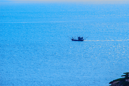 Colorful marine landscape with fisherman boat against deep blue sea under blue sky in the ocean on the cloudy day at Phuket, Thailand.の写真素材