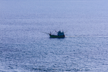 Colorful marine landscape with fisherman boat against deep blue sea under blue sky in the ocean on the cloudy day at Phuket, Thailand.の写真素材