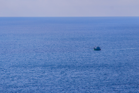 Colorful marine landscape with fisherman boat against deep blue sea under blue sky in the ocean on the cloudy day at Phuket, Thailand.の写真素材