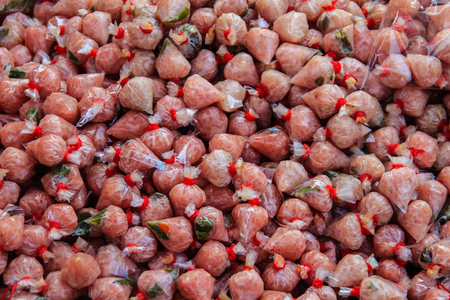 Close-up Thai style fermented sausage called Neam in a plastic bag wrap and ready for sell in Thailand fresh market.の写真素材