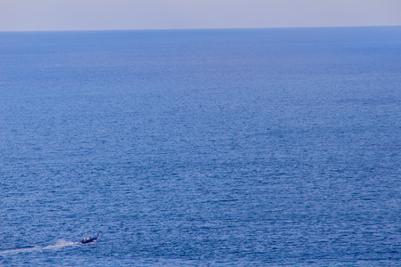 Colorful marine landscape with fisherman boat against deep blue sea under blue sky in the ocean on the cloudy day at Phuket, Thailand.の写真素材