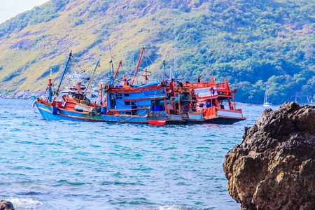 Colorful marine landscape with fisherman boat against deep blue sea under blue sky in the ocean on the cloudy day at Phuket, Thailand.の写真素材