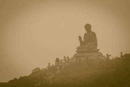 Tele zoom view of Giant Tian Tan Buddha statue on the peak of the mountain, view from Ngong Ping 360 cable car at Po Lin Monastery in Lantau Island, Hong Kongのeditorial素材