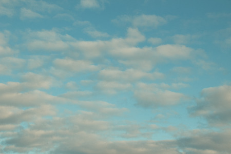 Beautiful cloudscape from sky aerial view. Beauty of nature view from above the sky and clouds. White clouds and blue sky view from airplane window. Sunlight in the sky shines on clouds.の写真素材