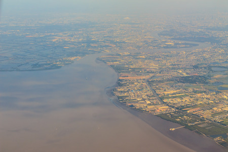 Bird's-eye view of Chaophraya river delta and gulf of Thailand landscapes from airplaneの写真素材