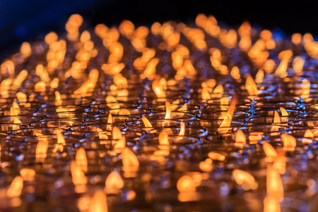 Orange candles in glasses from Chinese temple, Red candle is kindle a fire in glass at the Chinese temple, Prepare for Chinese new year. Shallow depth of field.の写真素材