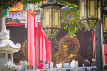 Tele zoom to the golden Buddha image face while people praying and pay respected at Wat Leng Noei Yi 2 in Thailand. It is the most famous and largest Chinese Buddhist temple in Thailand.のeditorial素材