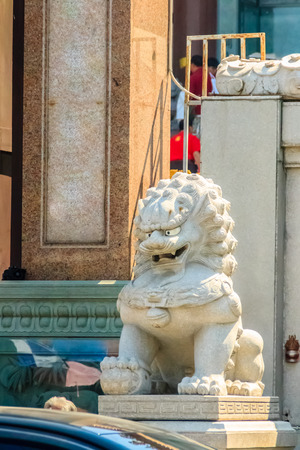 Stone Lion Guardian statue at the entrance gate of the Chinese temple in Thailand.の写真素材