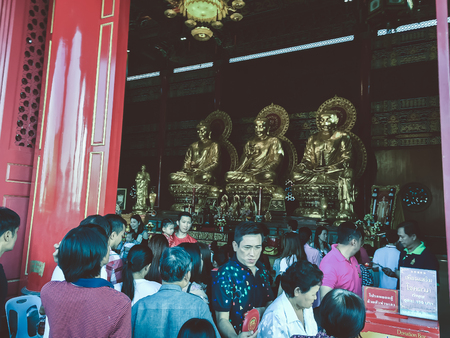 NONTHABURI, THAILAND - JAN 28, 2017: The tourist come to pray and made a merit at 3 Golden Buddha images in Chinese temple Thailand. Located at Wat Leng-noei-yi 2 during the Chinese new year festival.のeditorial素材