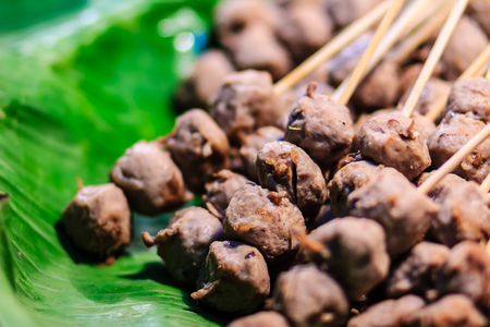 Meatballs grilled on banana leaves, the popular thai street food.の写真素材