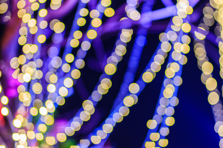 Beautiful blue bokeh abstract light background. Wonderful Defocused abstract blue christmas background. Abstract christmas lights as background in the night with noise grain and poor light.の写真素材