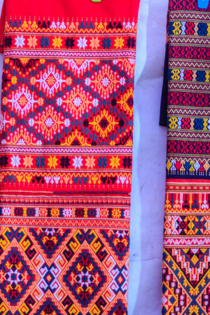 Colorful of native thai style silk and textiles pattern. Beautiful handmade woven fabrics thai silk fabric textured, with different native style patterns.の写真素材