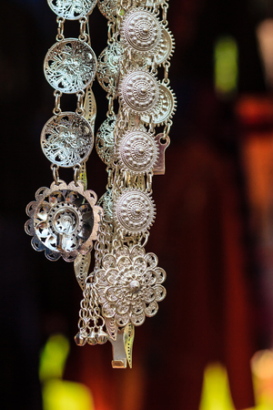 Beautiful Old antique vintage women silver belt hanging for sale in the local market at Northern Thailand.の写真素材
