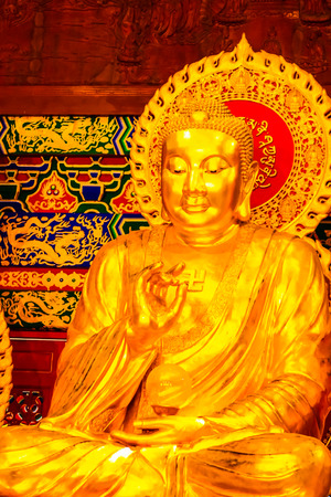 One of Three Golden Buddha statues for pray or make merit for the happiness life at Wat Borom Raja Kanjanapisek or Wat Leng Nei Yi 2, Nonthaburi, Thailand.の写真素材