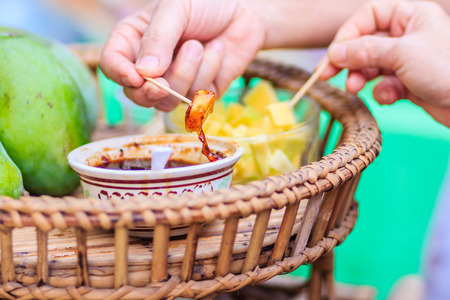 Raw Mango chips with sweet fish sauce for sale in the local market at Bangkok, Thailand.