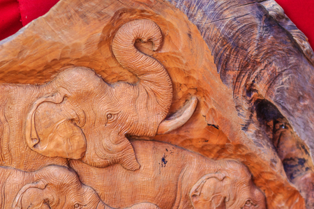 Beautiful Wood carving of elephant family. Antique Art Handmade Furniture which Carvings Elephant Family in The Wood. Elephant wooden crafted for sale in the local market at Northern Thailand.の写真素材
