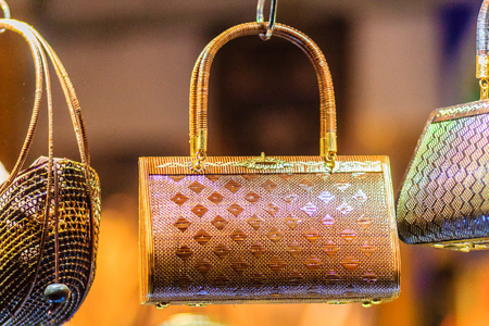 Beautiful lady handbags and basketry that made from Lygodium (climbing fern), or "Yan lipao" in Thai, the famous product from Southern Thailand for sale at night market, Bangkok. Night shot with grainの写真素材