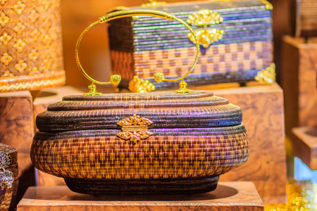 Beautiful lady handbags and basketry that made from Lygodium (climbing fern), or "Yan lipao" in Thai, the famous product from Southern Thailand for sale at night market, Bangkok. Night shot with grainの写真素材