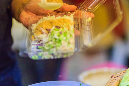 Vendor is selling for Nasi kerabu or khao yum, the popular food in Southern Thai-Style rice with herbs and vegetables. Nasi kerabu is a Malay rice dish, a type of nasi ulam.の写真素材