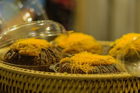 Custard in pumpkin, pumpkin custard with sweet egg floss topping, Thai dessert at night market in Bangkok, Thailand.の写真素材