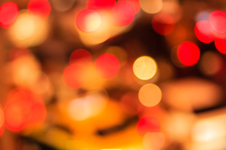 Abstract blur bokeh of Evening traffic jam on road in city. Out of focus lights from cars in a traffic jam. Defocused lights car traffic jam of a street road at night. Road traffic jam by blur focus.の写真素材