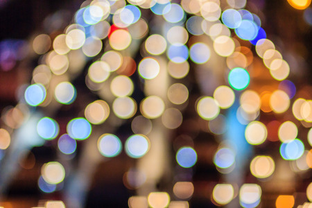 Abstract blur bokeh of Evening traffic jam on road in city. Out of focus lights from cars in a traffic jam. Defocused lights car traffic jam of a street road at night. Road traffic jam by blur focus.の写真素材