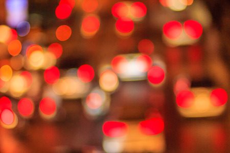 Abstract blur bokeh of Evening traffic jam on road in city. Out of focus lights from cars in a traffic jam. Defocused lights car traffic jam of a street road at night. Road traffic jam by blur focus.の写真素材