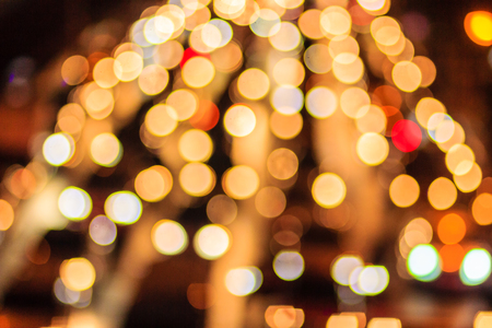 Abstract blur bokeh of Evening traffic jam on road in city. Out of focus lights from cars in a traffic jam. Defocused lights car traffic jam of a street road at night. Road traffic jam by blur focus.の写真素材