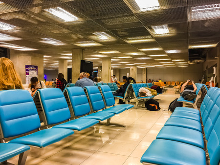 Bangkok,Thailand - February 21, 2017: Unidentified tired passenger is sleeping on the chairs in Suvarnabhumi international airport terminal and waiting for morning flight.のeditorial素材