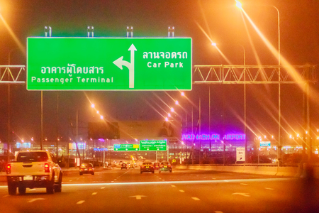 Bangkok, Thailand - February 21, 2017: Tourist is during on the way to Suvarnabhumi International Airport for morning flight at 0500 hours. Shot in taxi on late night with poor light and grain.のeditorial素材