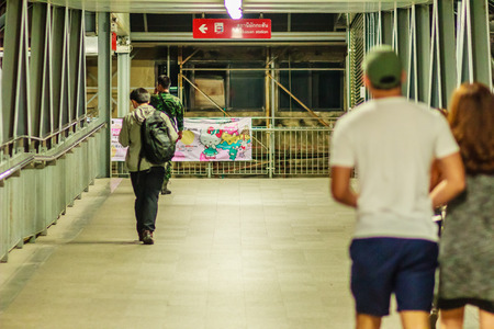 Bangkok, Thailand - February 21, 2017: Late night, People walk on sky walk way connect between Makkasan airport rail link station and Petchaburi MRT (Metropolitan Rapid Transit) subway station.のeditorial素材
