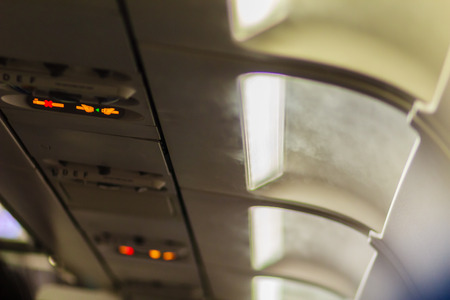 No Smoking and Fasten Seat belt Sign Inside an Airplane. Fasten seat belt and no smoking sign in aircraftの写真素材