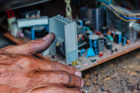Electrician repairing a TV in old television repair shopの写真素材