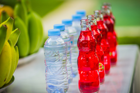Set of fresh tropical fruits including banana, orange, pineapple, fresh water, red water, coconut, apple, mango, grape, longan, prepared for the spirits of the gods  worship ceremonyの写真素材