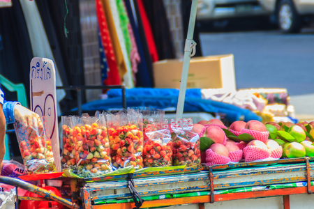 Bangkok, Thailand - March 2, 2017: Fresh red strawberries and apples for sale on street in Bangkok, Thailand. Street  fruit shop selling fresh strawberry and apple.のeditorial素材