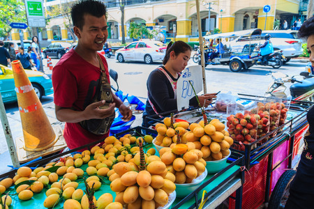 Bangkok, Thailand - March 2, 2017: Plango fruit vendor in Bangkok, Plango fruit or Marian Plum, famous tropical fruit in Thailand. Sweet Maprang or Mayongchid (Bouae bumanica Griff)のeditorial素材