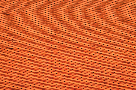 Old antique orange roof tiles pattern at the buddha temple in thailandの写真素材