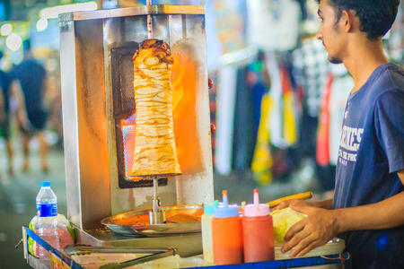 Bangkok, Thailand - March 2, 2017:  Street vendor is selling grilled kebab, the popular street foods at Khao San Road night market, Bangkok, Thailand.のeditorial素材