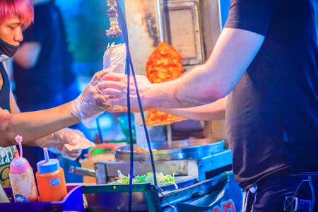 Bangkok, Thailand - March 2, 2017:  Street vendor is selling grilled kebab, the popular street foods at Khao San Road night market, Bangkok, Thailand.のeditorial素材