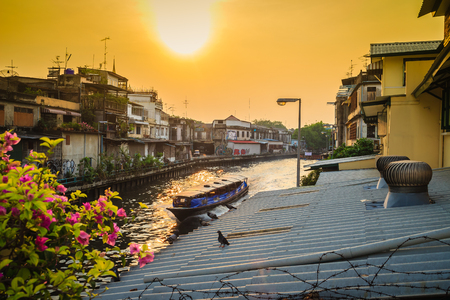 Canal Boat passing by Khlong Mahanak River in Bangkok nearby Wat Saket Ratcha Wora Maha Wihan (Wat Phu Khao Thong, Golden Mount temple), a popular Bangkok tourist attraction.のeditorial素材