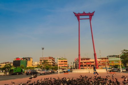 Red giant swing or Sao Ching Cha with the crowd of pigeon, one of the most famous tourist attraction and landmark in Bangkok, Thailand.の写真素材
