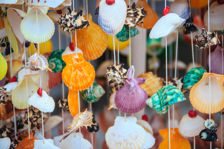 Beautiful seashell mobile hanging in the shop for sale. Handicrafts produced by the shell wall, souvenirs from the seaside.の写真素材