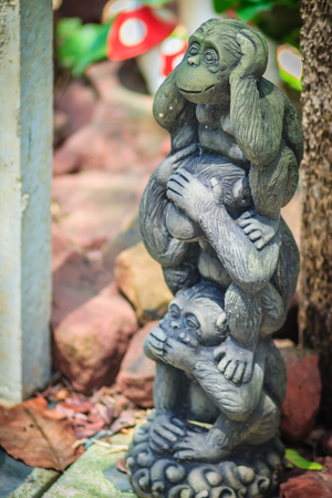 Three monkey dolls are molded using hand action close ears,eyes and mouth. To stop the gossip concept.の写真素材